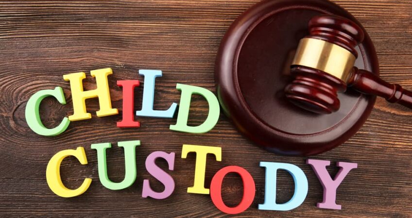 A gavel and colourful letters regarding child-custody and family-law concept